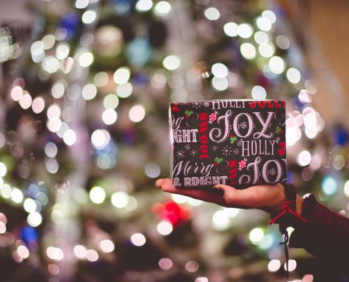 charitable gift tax limits - hand holding christmas gift