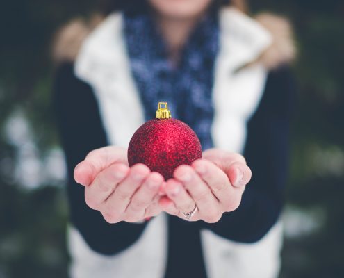 Hands giving ornament