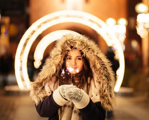 woman holding sparkler for stocks