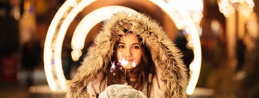 woman holding sparkler for stocks