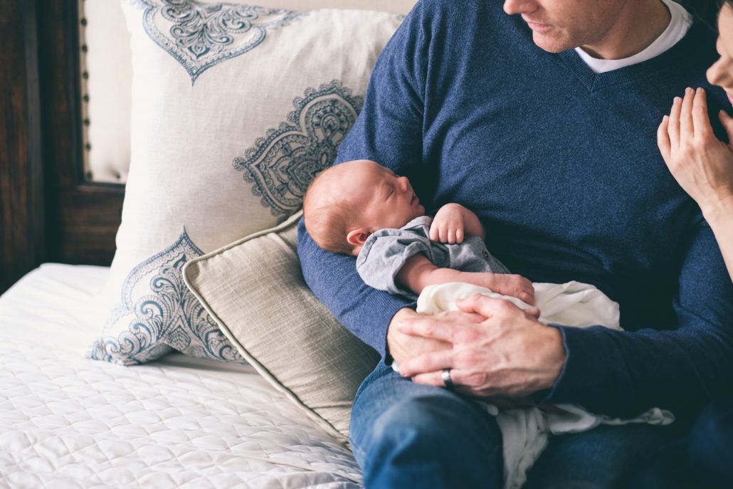 Baby in arms of dad