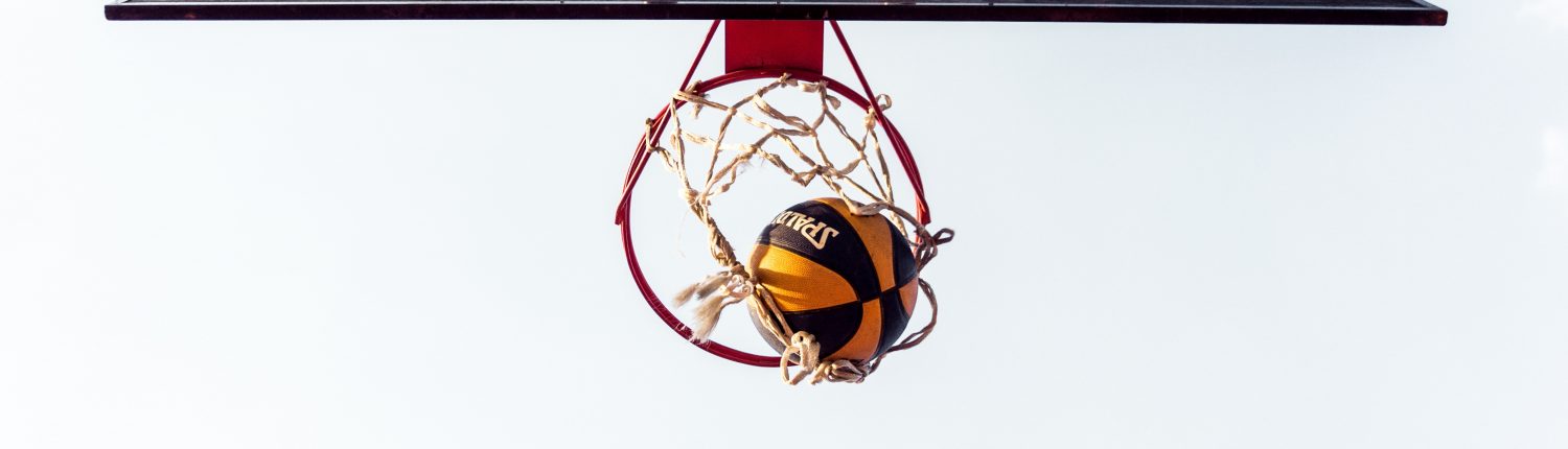 basketball court with ball in hoop