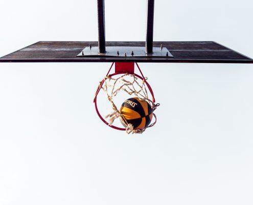 basketball court with ball in hoop