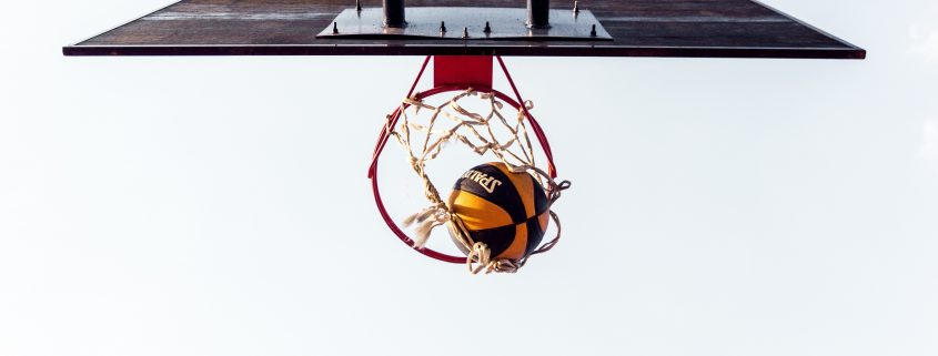 basketball court with ball in hoop