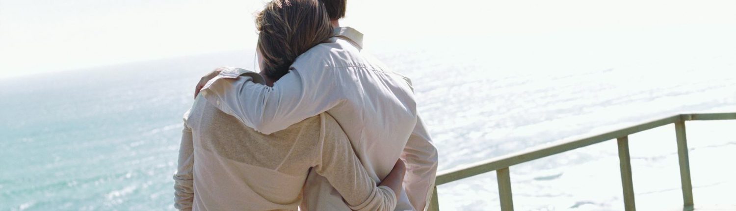 Couple overlooking ocean on boat