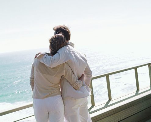 Couple overlooking ocean on boat