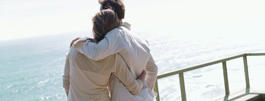 Couple overlooking ocean on boat