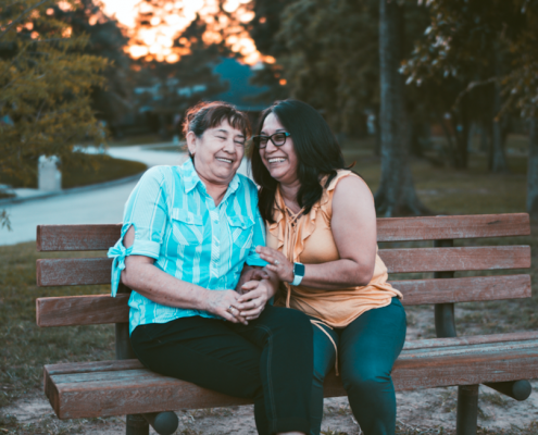 two women sitting on bench