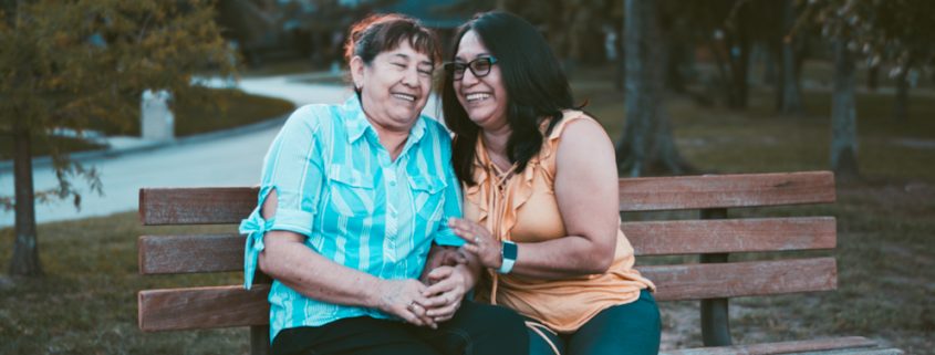 two women sitting on bench