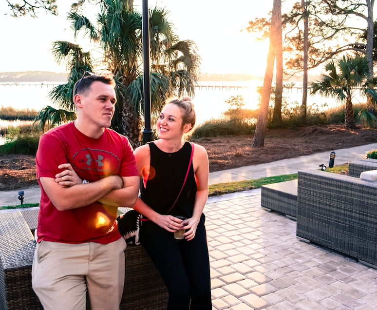 two young people talking near beach