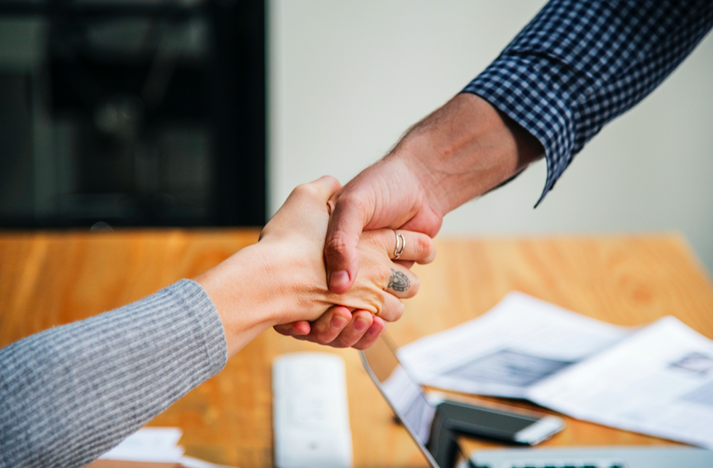 handshake over table