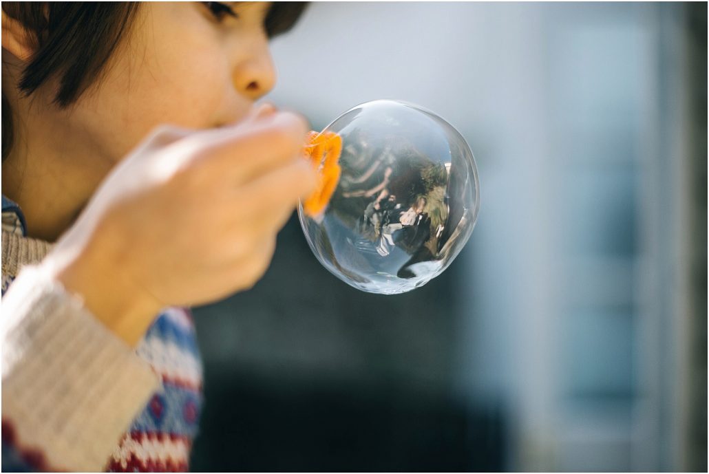 girl blowing bubbles