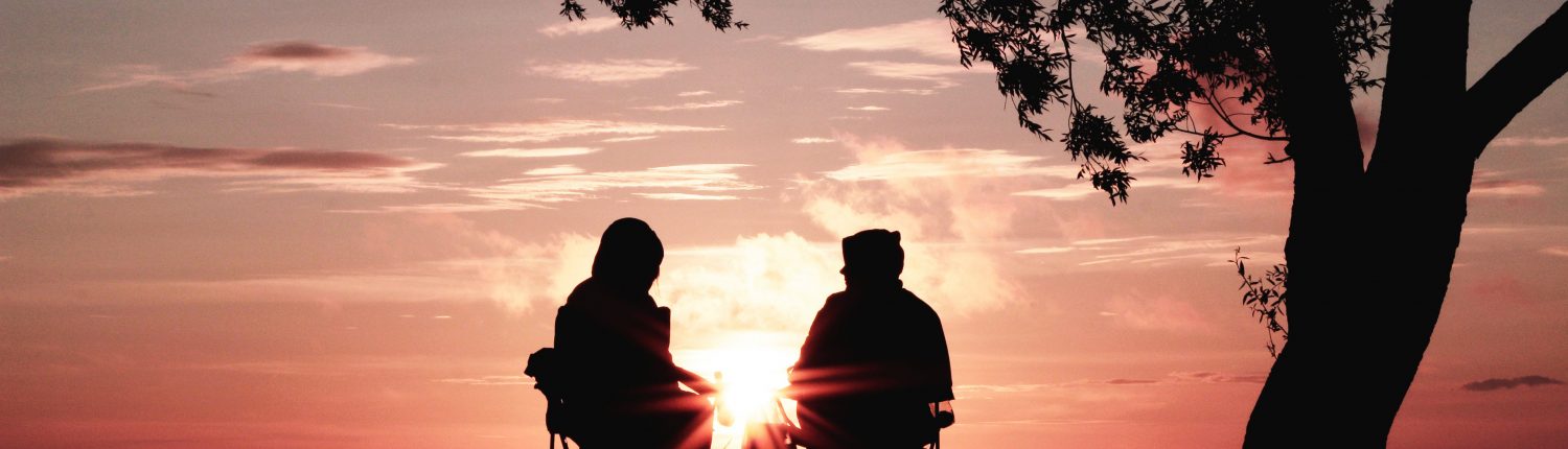 Two people looking at sunset