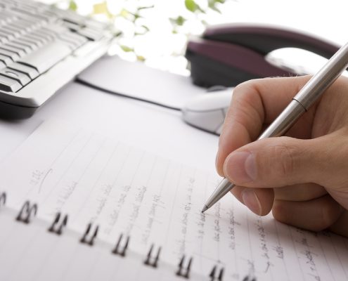 Businessman taking notes and planning in a meeting