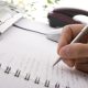 Businessman taking notes and planning in a meeting