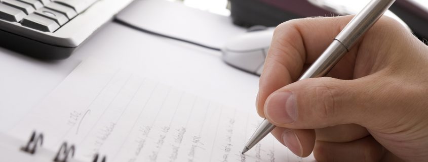 Businessman taking notes and planning in a meeting