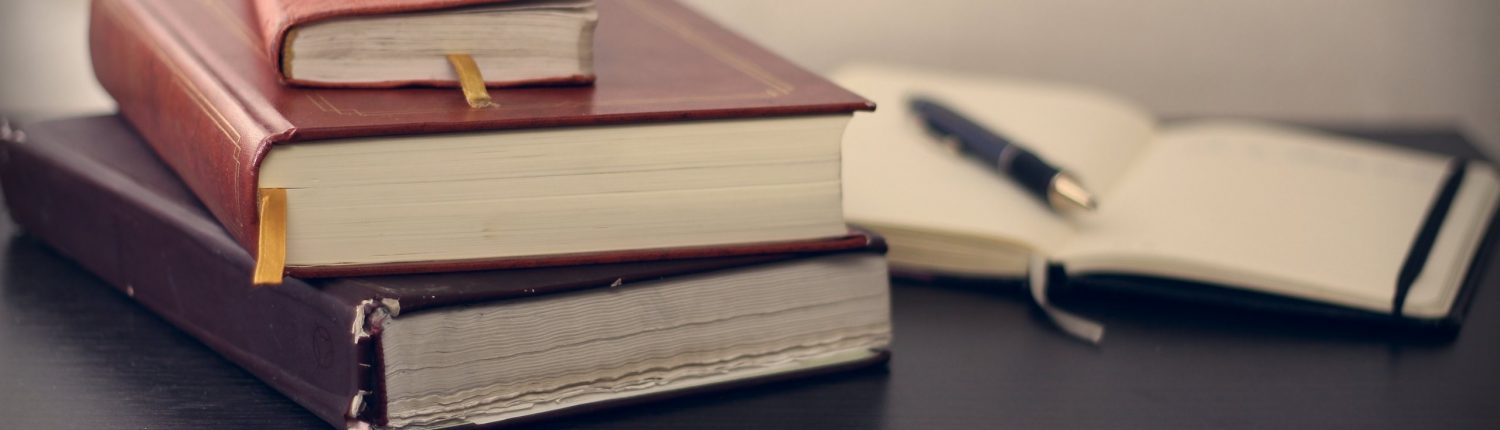 Stacked books and notebook