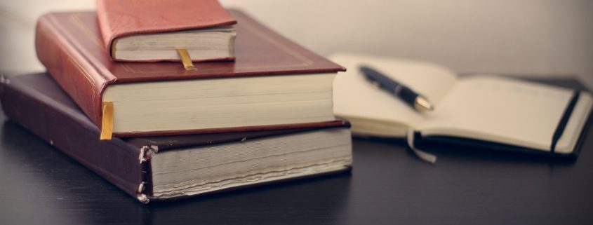 Stacked books and notebook