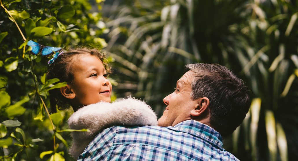 Dad holding daughter