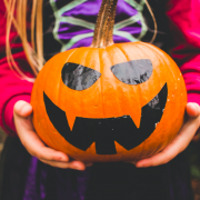 Girl holding scary pumpkin