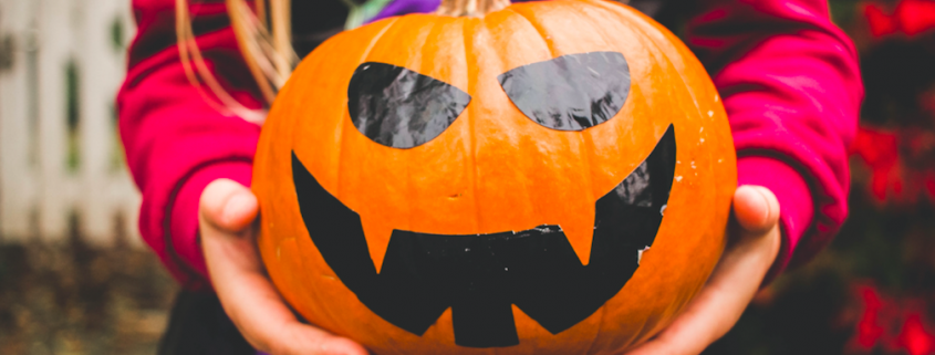 Girl holding scary pumpkin