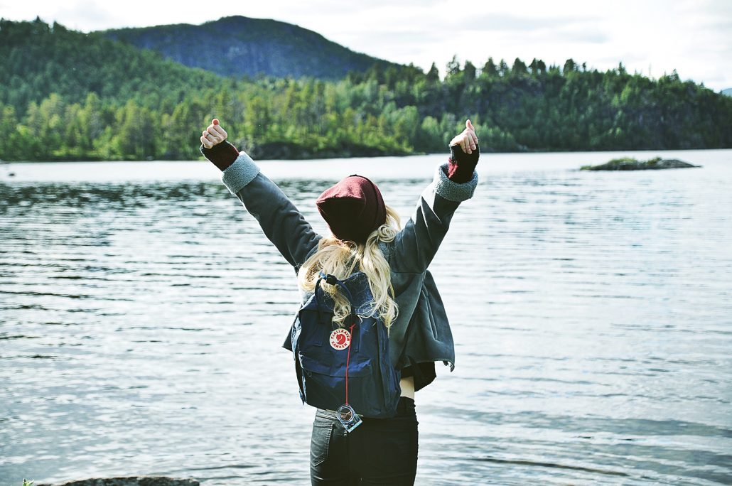 woman cheering at water's edge