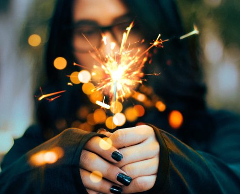 person with sparkler spooky