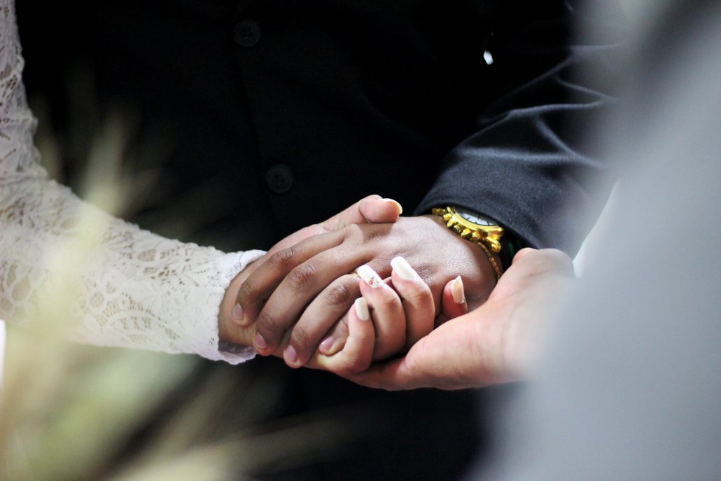 Bride and groom holding hands