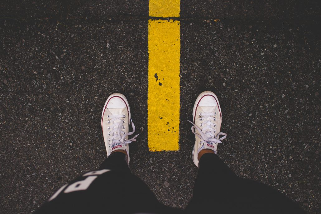 Standing over yellow line in road- community property