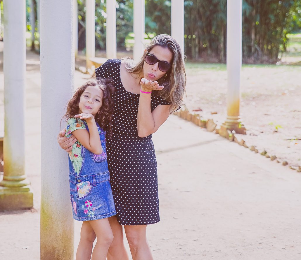 mom daughter blowing kiss