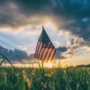 Flag in field with sun