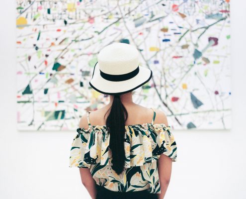 woman in front of painting