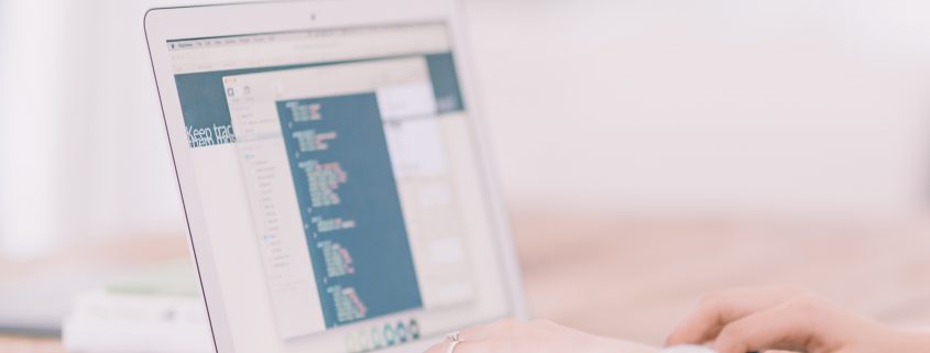 hands typing on computer