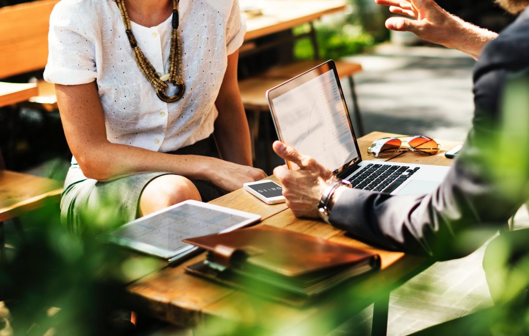 discussion over table with laptop