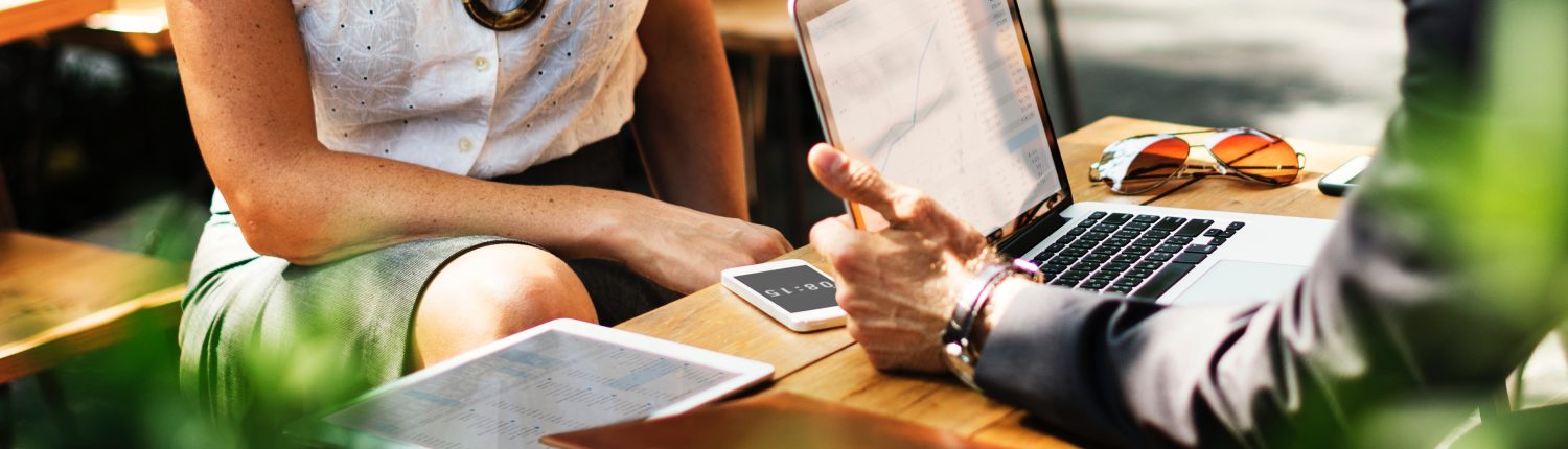 discussion over table with laptop