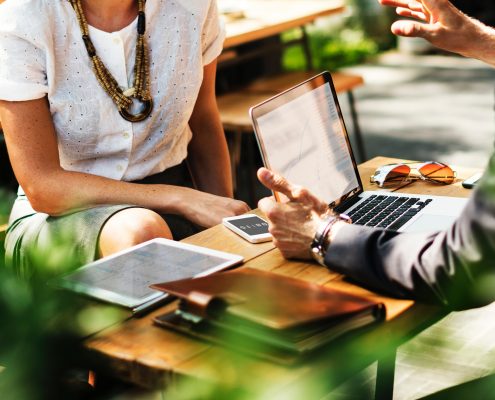 discussion over table with laptop
