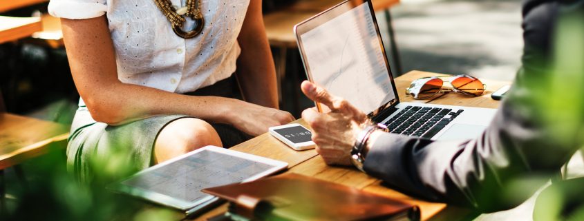 discussion over table with laptop