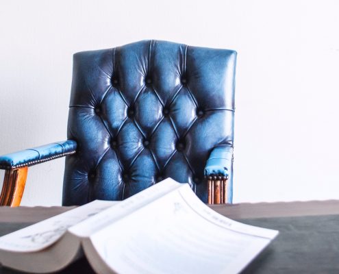 Conflict of Interest chair with book on table