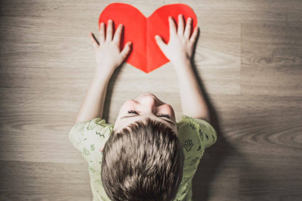 child with red heart