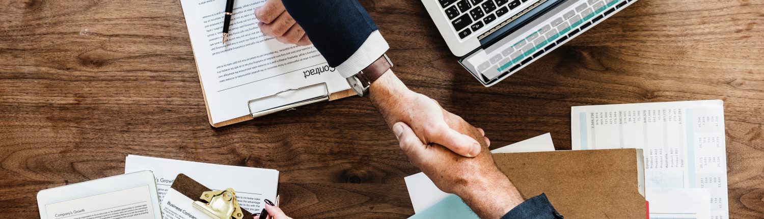 shaking hands across table