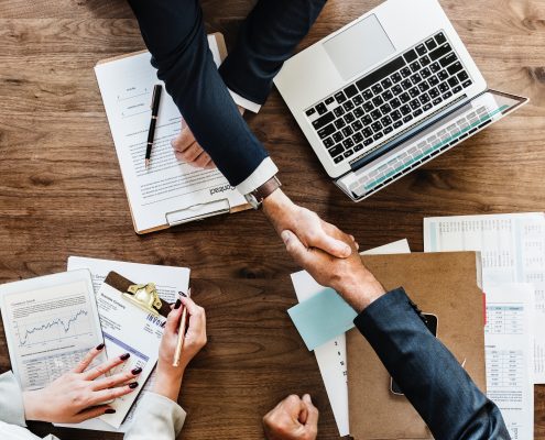 shaking hands across table