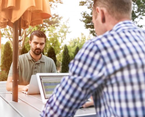 men on computer at table