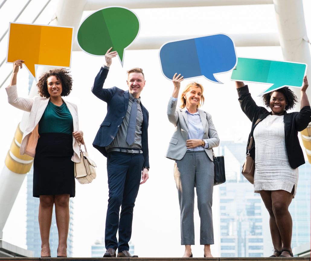 team members holding speech bubbles