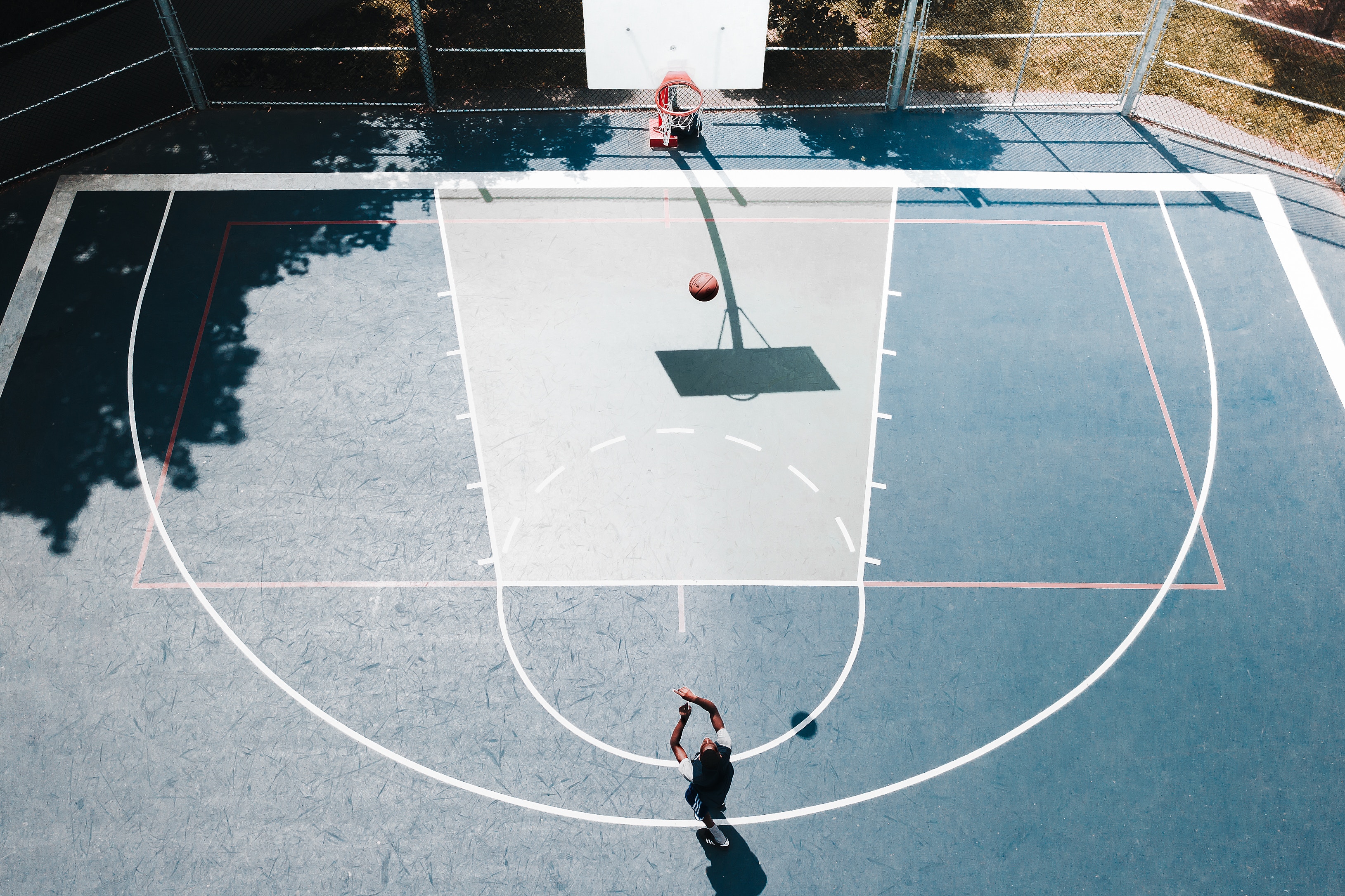 person shooting on basketball court