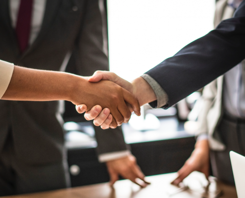 shaking hands over interview table