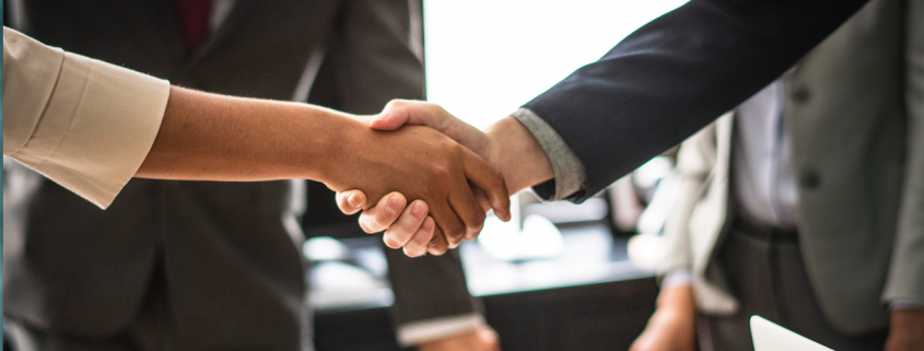 shaking hands over interview table