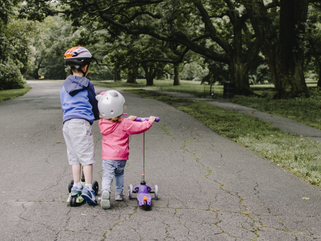 two kids on scooters