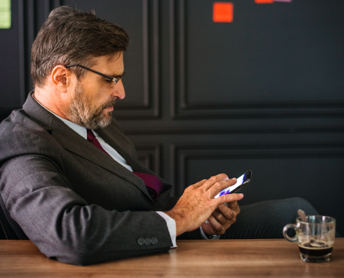 Man sitting at conference table with phone