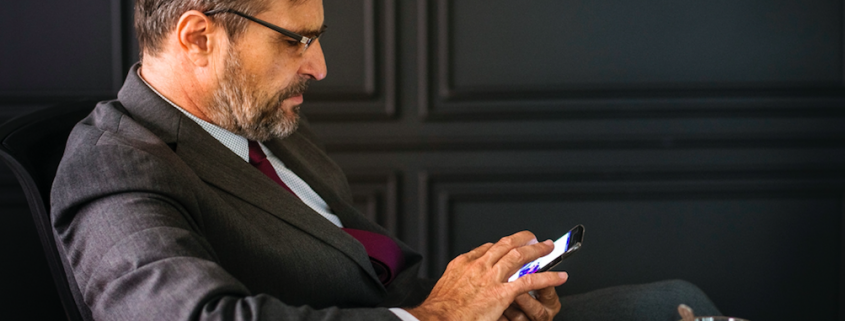 Man sitting at conference table with phone