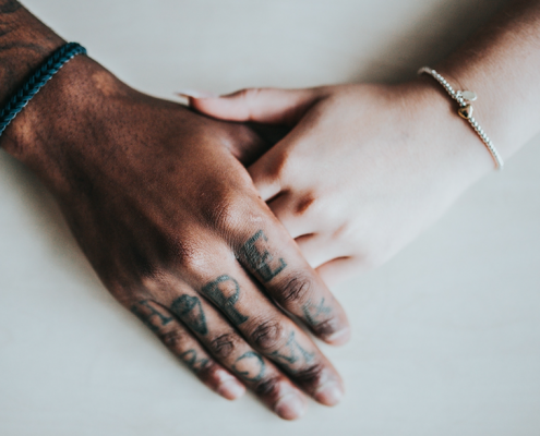 two people holding hands on white background